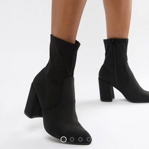 Black pointed “sock style” heeled boots